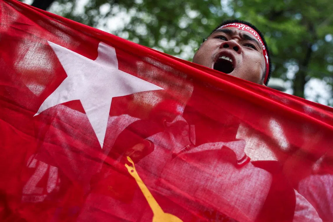 FILE PHOTO: A protester holds a flag as he shouts slogans during a demonstration to mark last year's anniversary of Myanmar?s 2021 military coup, outside the United Nations office in Bangkok, Thailand, February 1, 2024. REUTERS/Chalinee Thirasupa/File Photo
