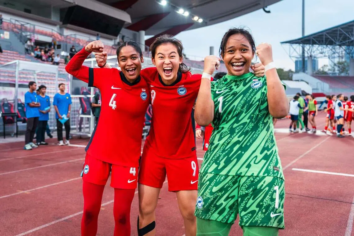 Izairida Shakira (far right) celebrating Singapore’s 4-3 penalty shoot-out win over Cambodia with teammates Umairah Hamdan (far left) and Danelle Tan.