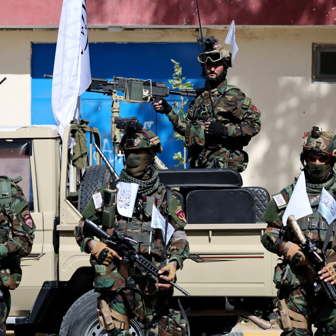 Members of the Taliban stand guard during a rally to mark five years in power, outside the former U.S. embassy in Kabul, Afghanistan, August 15, 2026. REUTERS/Sayed Hassib