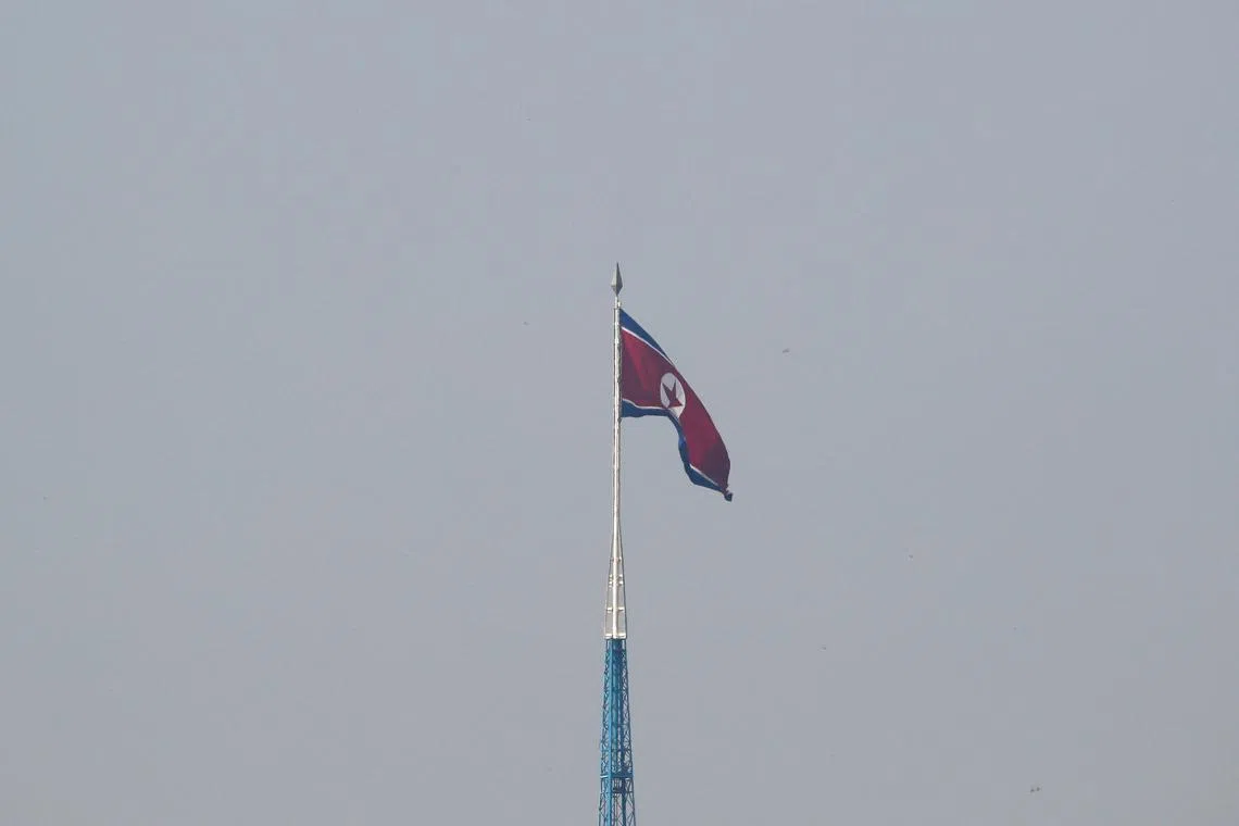 FILE PHOTO: A North Korean flag flutters on top of the 160-metre tall tower at North Korea's propaganda village of Gijungdong, in this picture taken from Tae Sung freedom village near the Military Demarcation Line (MDL), inside the demilitarised zone separating the two Koreas, in Paju, South Korea, September 30, 2019. REUTERS/Kim Hong-Ji/File Photo