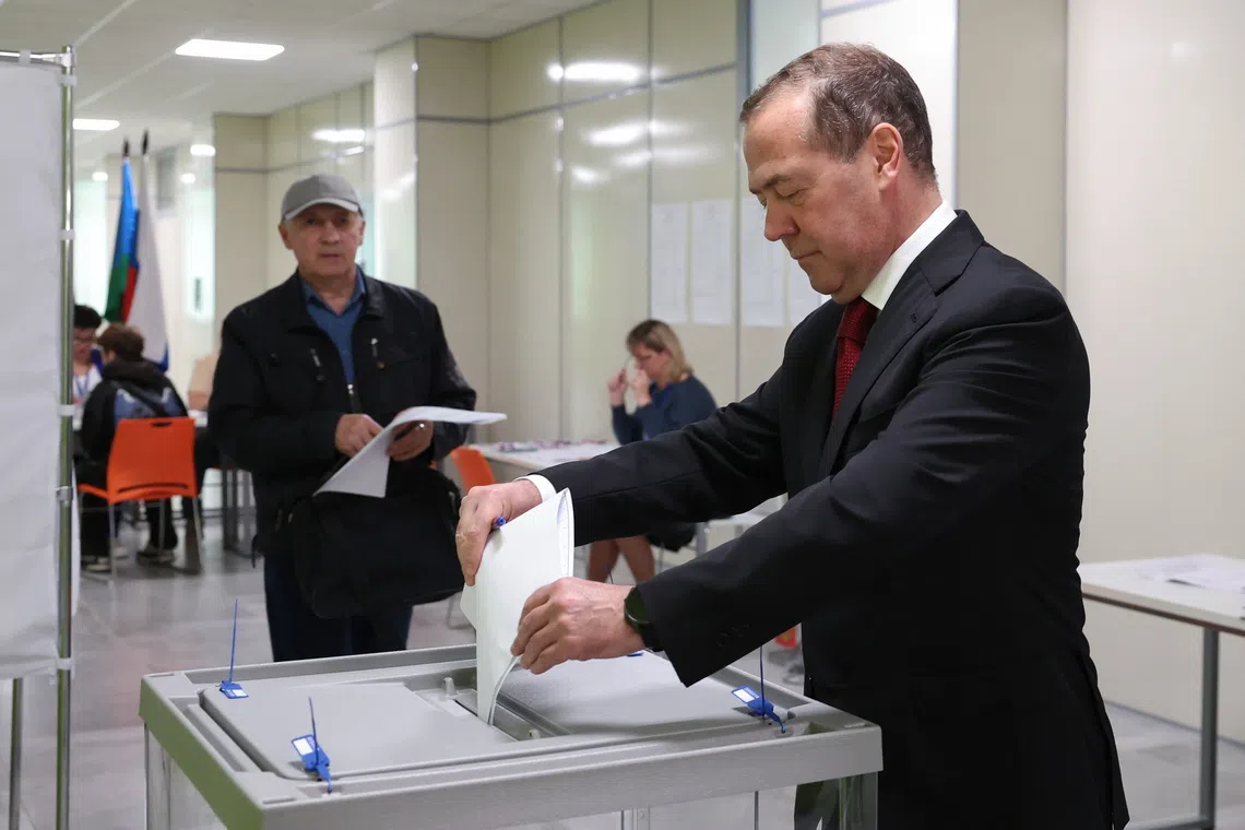 Deputy Chairman of the Russian Security Council and leader of the United Russia political party Dmitry Medvedev casts his ballot at a polling a station in Moscow, on Sept 18.