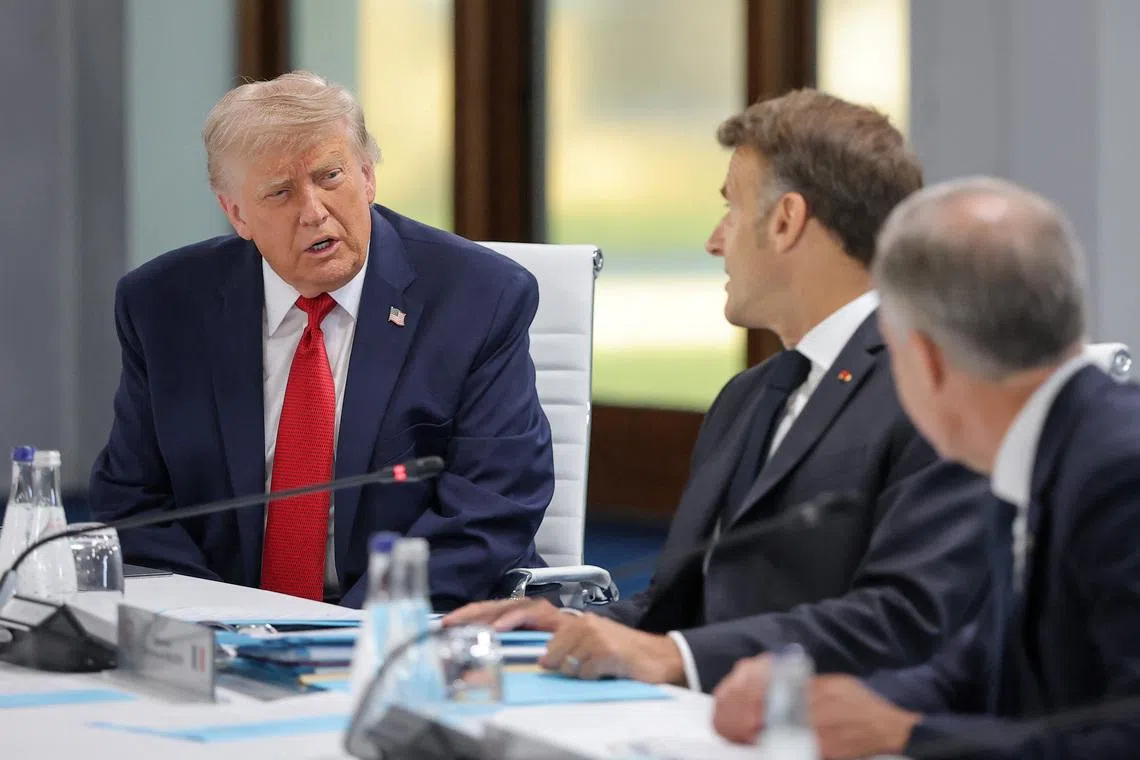U.S. President Donald Trump and French President Emmanuel Macron attend a working session with G7 leaders and outreach partners on promoting economic growth, during the G7 Summit in Evian-les-Bains, France, June 17, 2026. REUTERS/Christian Hartmann