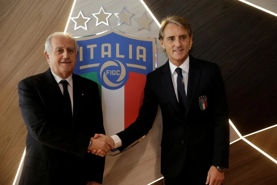 FILE PHOTO: Soccer Football - Italy - Roberto Mancini Press Conference - Coverciano, Florence, Italy - May 15, 2018    New Italy coach Roberto Mancini and Italian FA commissioner Roberto Fabbricini pose during the press conference   REUTERS/Max Rossi/File Photo