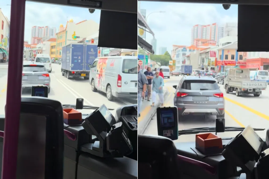 A silver car is seen driving slowly ahead of the bus, before turning into the bus lane and coming to a momentary stop at a bus stop.
