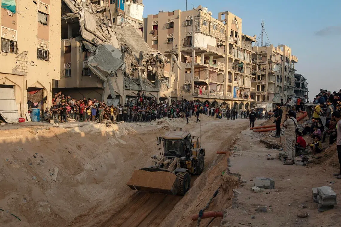 An excavator works at a site where the bodies of Israeli hostages are believed to be buried.
