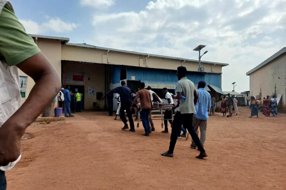 A person wounded in a drone strike on a market in the disputed Abyei region along the border between South Sudan and Sudan is carried to Ameth Bek hospital, October 19, 2026. REUTERS/Medecins Sans Frontieres/Handout via REUTERS