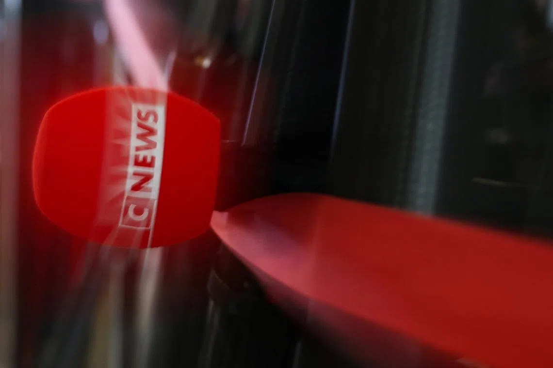 The logo of CNEWS is displayed on a microphone as journalists work at the Paris courthouse in Paris, France, April 29, 2026. Picture taken with a long exposure. REUTERS/Gonzalo Fuentes