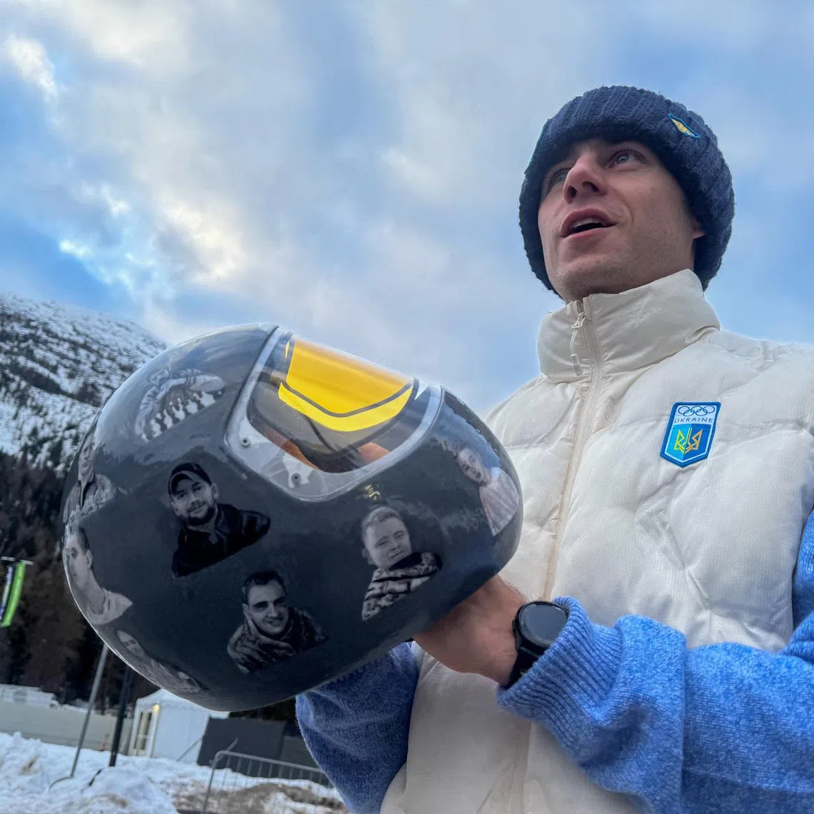 Ukrainian skeleton athlete Vladyslav Heraskevych holds his helmet with images of compatriots killed during the war in Ukraine, at the Milano Cortina Gamesin in Cortina D'Ampezzo, Italy, February 9, 2026. REUTERS/Cristiano Corvino