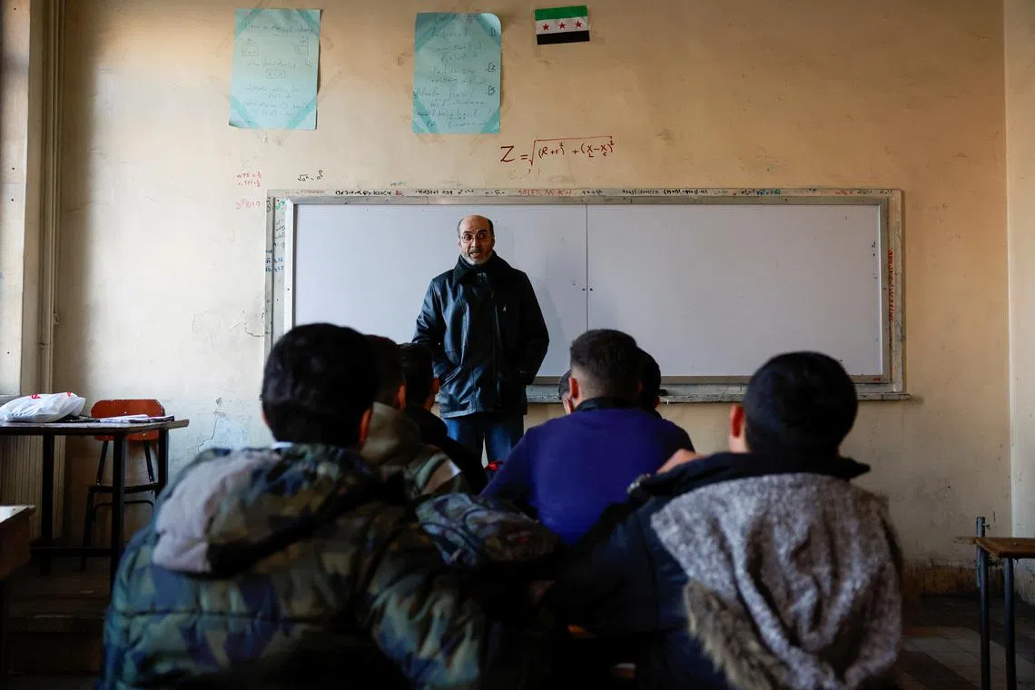 Students sit in a classroom at a school in the early morning following an announcement of the reopening of schools by the authorities, after the ousting of Syria’s Bashar al-Assad, in Damascus, Syria December 15, 2024. REUTERS/Ammar Awad
