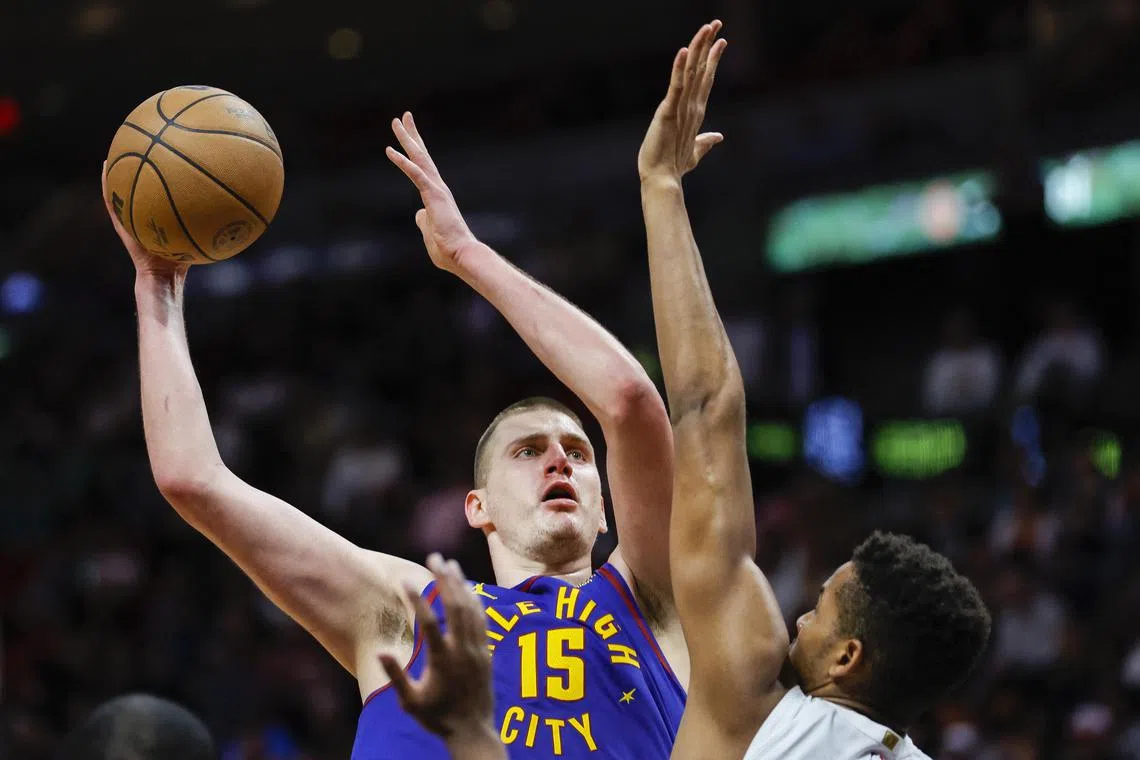 Denver Nuggets center Nikola Jokic (15) shoots the basketball over Miami Heat center Orlando Robinson (25) during the third quarter.
