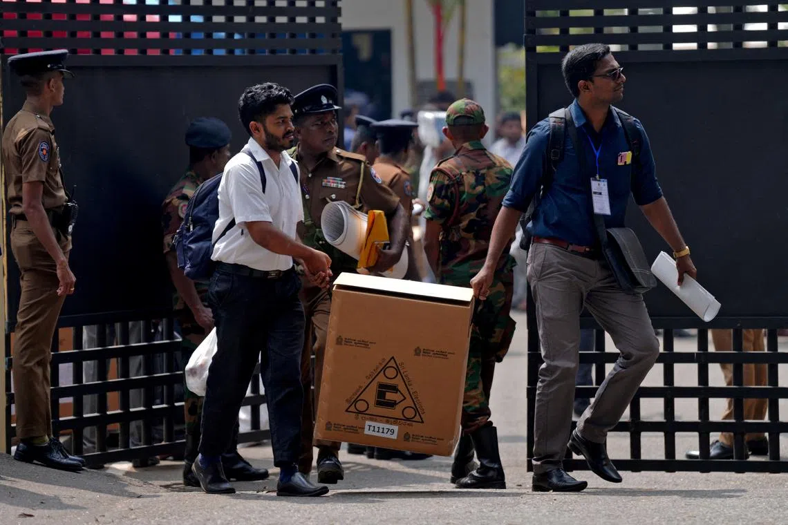 Polling officials and police officers carry election materials after collecting them from a distribution centre, a day before the Parliamentary Election, in Colombo, Sri Lanka, November 13, 2024. REUTERS/Thilina Kaluthotage