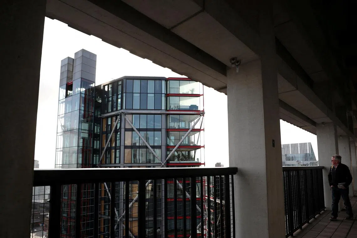 FILE PHOTO: Visitor looks out from the Viewing Level towards a luxury block of flats from the Tate Modern gallery in London, Britain, February 12, 2020. REUTERS/Hannah McKay/File Photo