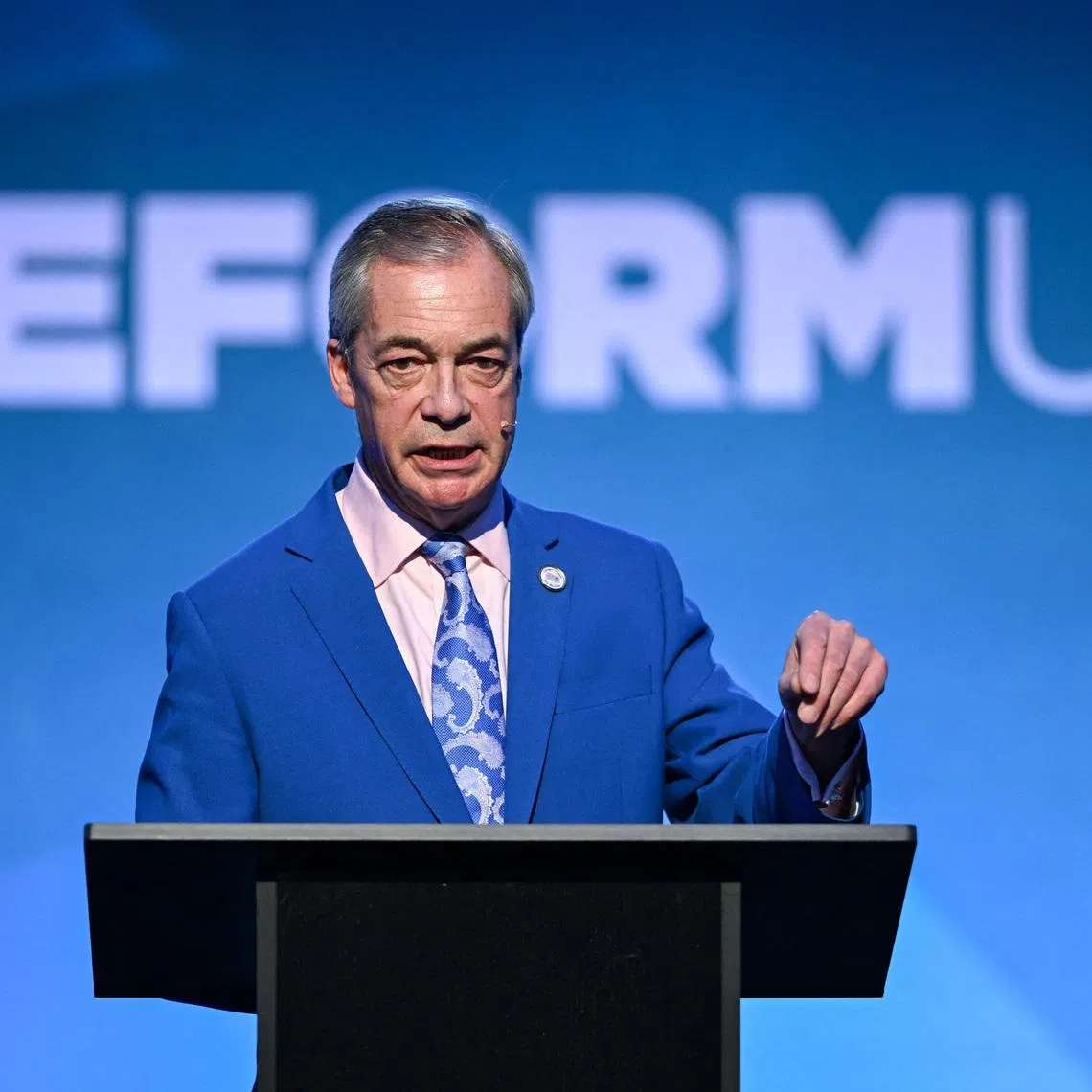 Britain's Reform UK leader Nigel Farage responds to a question from a member of the media after announcing members of the party's shadow cabinet, in London, Britain, February 17, 2026. REUTERS/Chris J. Ratcliffe