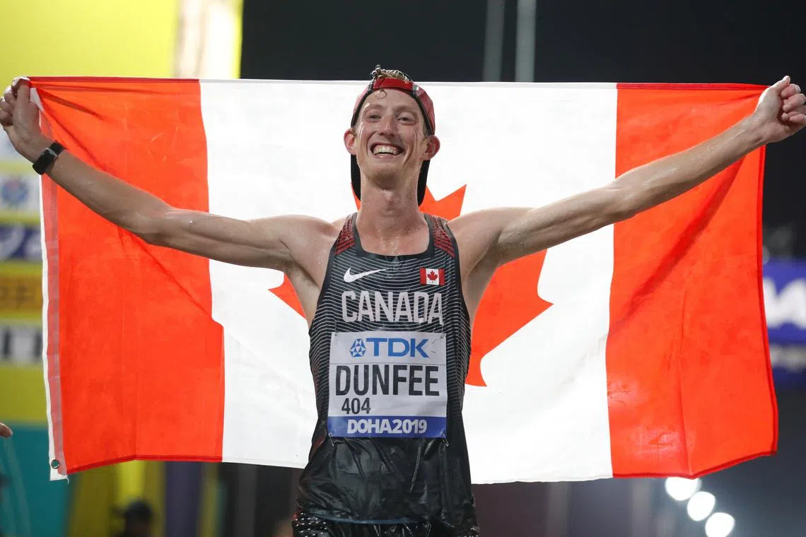 FILE PHOTO: Athletics - World Athletics Championships - Doha 2019 - Men's 50 Kilometres Race Walk - Doha, Qatar - September 29, 2019  Canada's Evan Dunfee poses as he celebrates winning bronze REUTERS/Aleksandra Szmigiel/File Photo