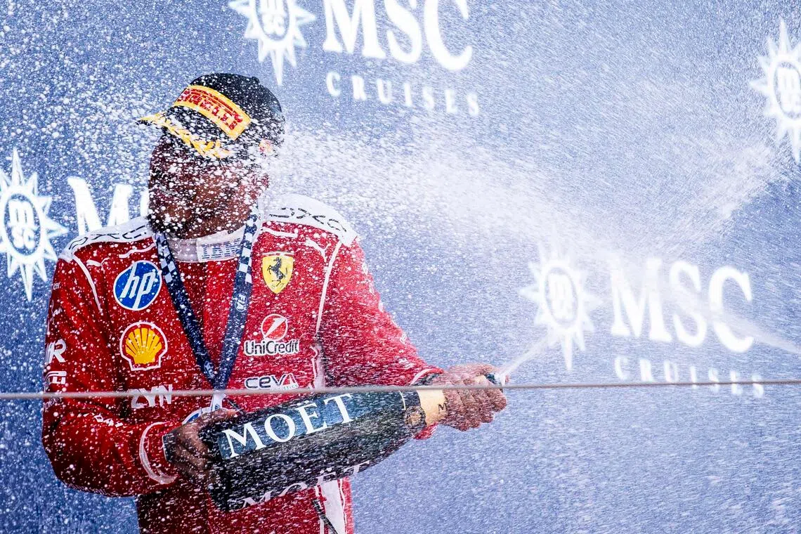 Ferrari driver Lewis Hamilton celebrates on the podium after the Formula 1 Grand Prix of Barcelona-Catalunya.