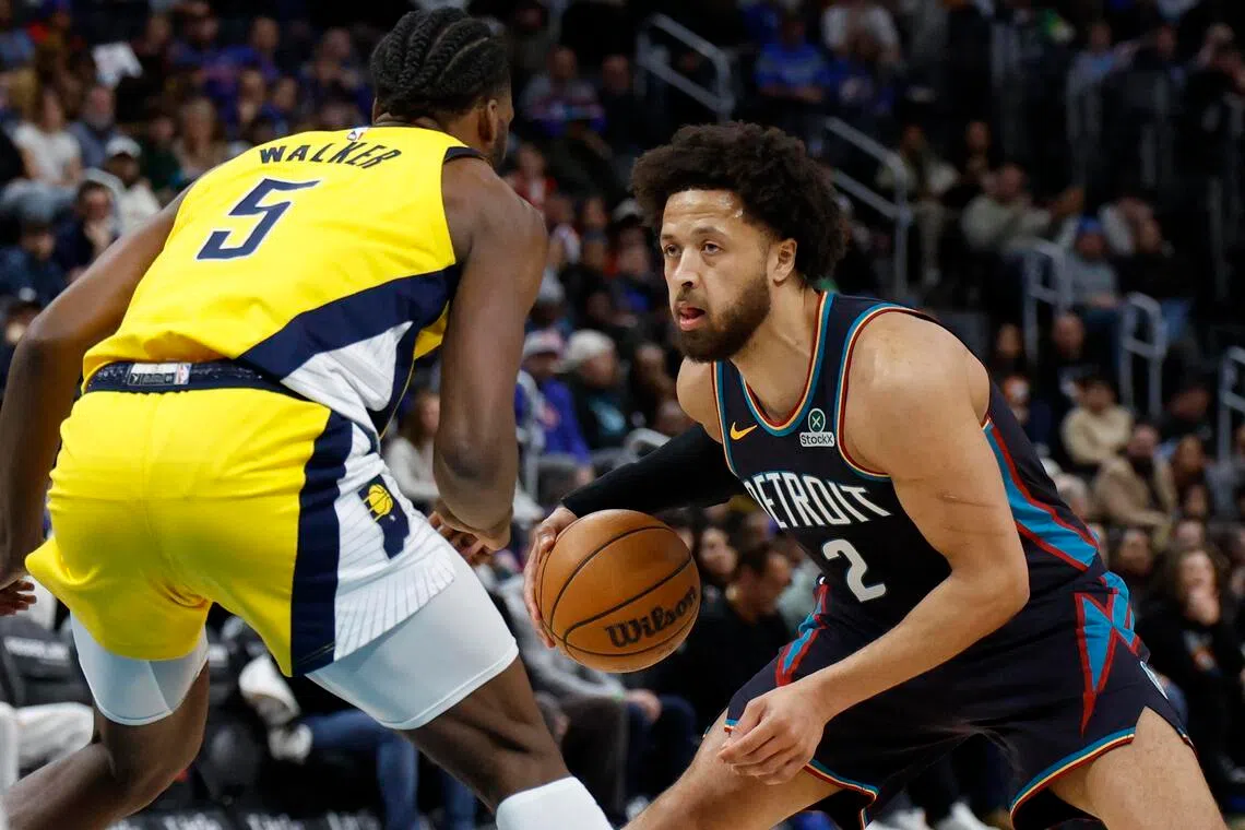 Jan 17, 2026; Detroit, Michigan, USA;  Detroit Pistons guard Cade Cunningham (2) dribbles defended by Indiana Pacers forward Jarace Walker (5) in the first half at Little Caesars Arena. Mandatory Credit: Rick Osentoski-Imagn Images