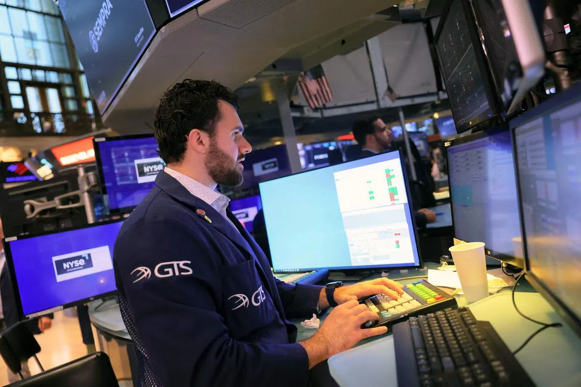 Traders work on the floor of the New York Stock Exchange, during morning trading, in New York City. 