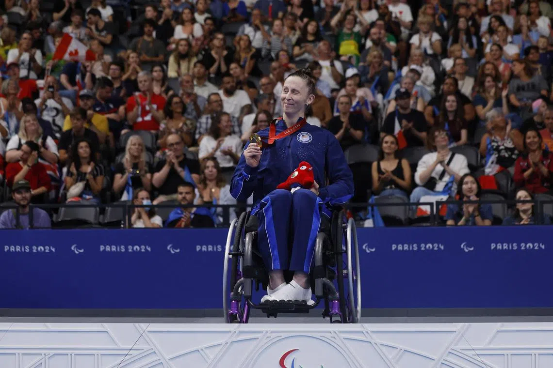 Gold medallist Leanne Smith of the United States celebrates on the podium after winning the 100m freestyle S3 at the Paris Paralympics.