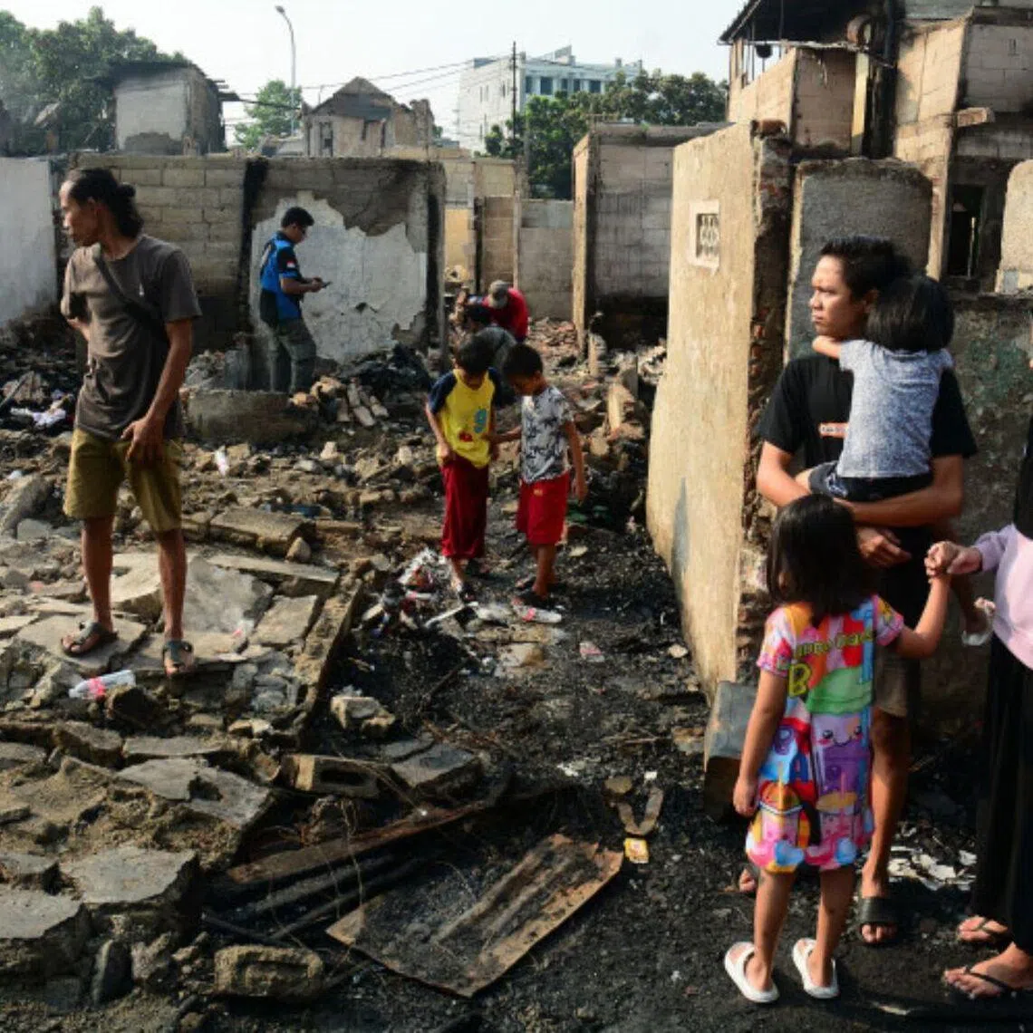 Residents inspect the remains of their homes after a fire broke out in the Kebon Kosong sub-district in Central Jakarta on June 1.