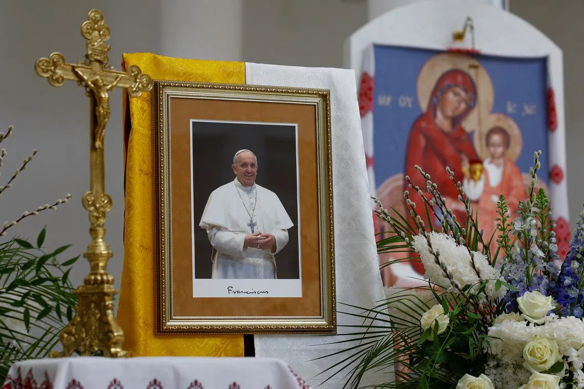 A portrait of Pope Francis is seen inside the Cathedral of the Resurrection of Christ of the Greek Catholic Church, after the death of Pope Francis was announced by the Vatican, in Kyiv, Ukraine April 21, 2025. REUTERS/Valentyn Ogirenko