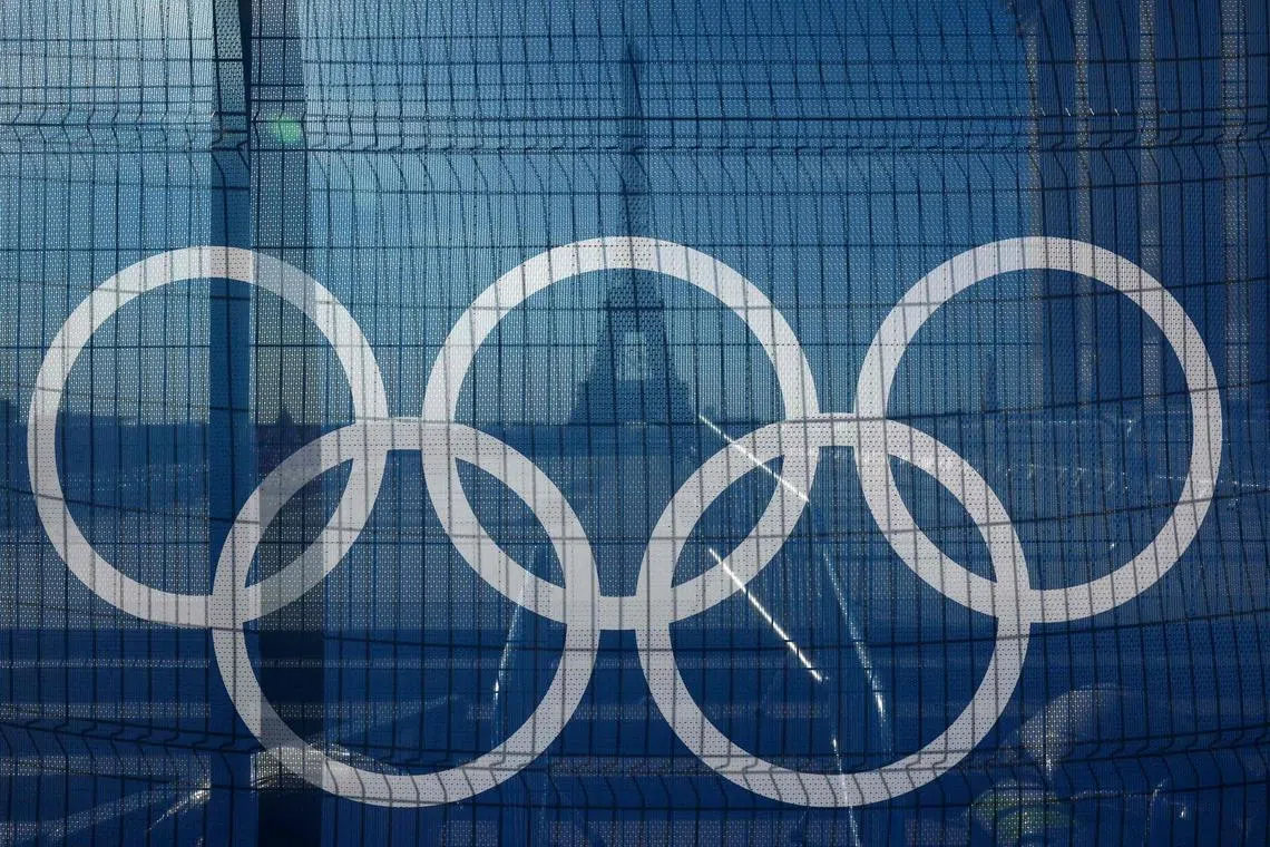 This photograph shows a tarpaulin bearing Olympic rings at the Trocadero with the Eiffel Tower in the background in Paris on July 15, 2024, ahead of the Paris 2024 Olympic and Paralympic Games.