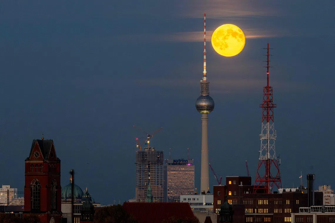 November's full moon, also known as Beaver Moon, rising behind the landmark TV tower on Berlin's Alexanderplatz in Germany on Nov 6, 2025. 