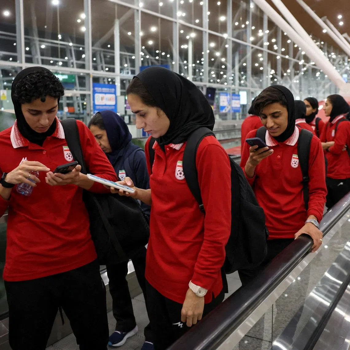 Members of the Iranian women's national soccer team arrive at Terminal 1 of Kuala Lumpur International Airport after attending a match in Group A of the AFC Women's Asian Cup in Australia, at Sepang, Malaysia, March 11, 2026. REUTERS/Hasnoor Hussain