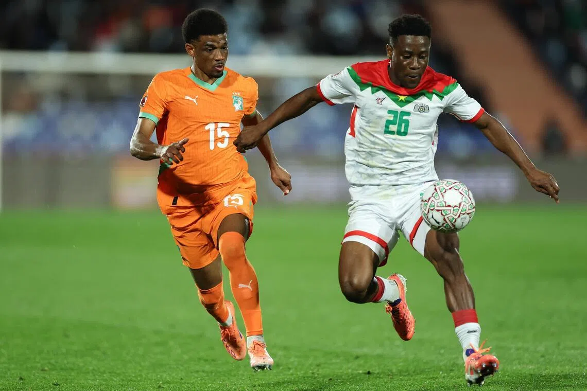 Ivory Coast forward Amad Diallo closing down Burkina Faso defender Arsene Kouassi in their Africa Cup of Nations round-of-16 football match at the Grand Stadium in Marrakesh on Jan 6, 2026.