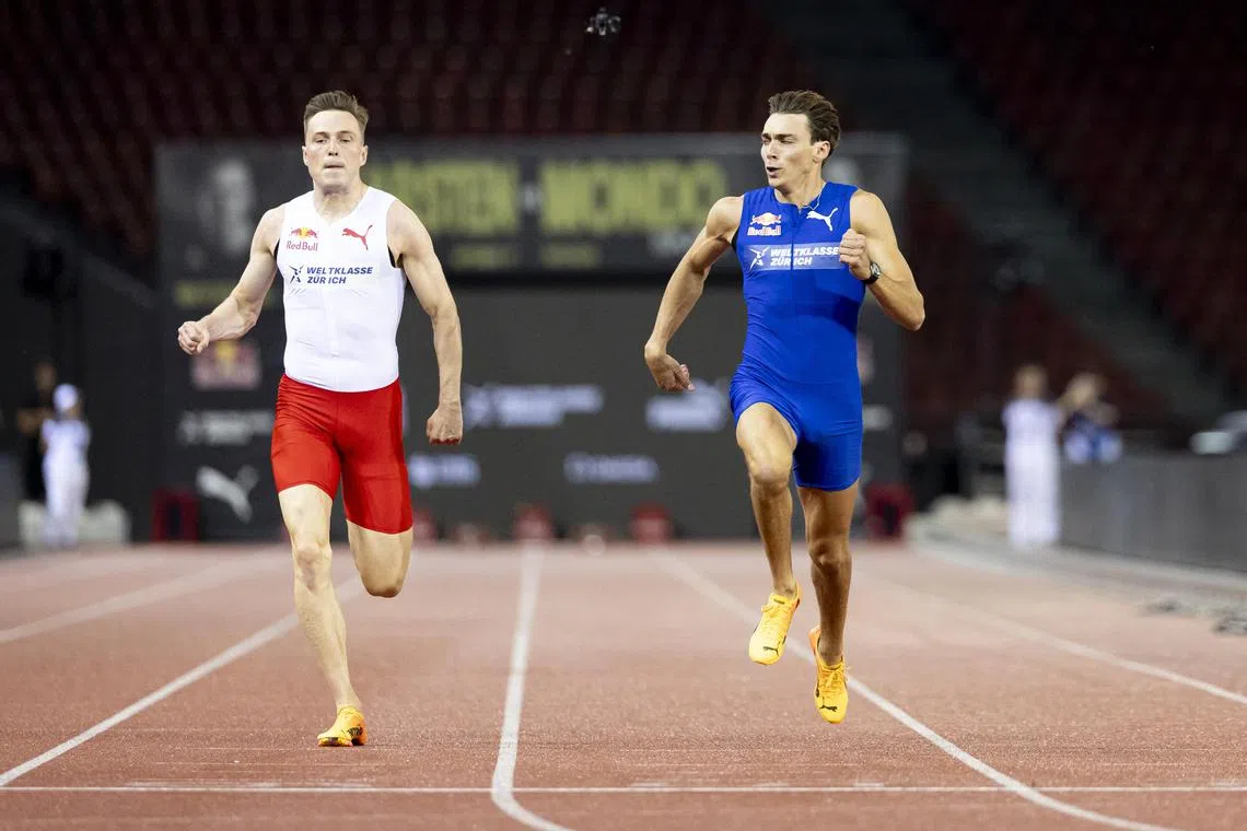 Swedish pole vaulter Armand Duplantis (right) crosses the line ahead of Norwegian hurdler Karsten Warholm.