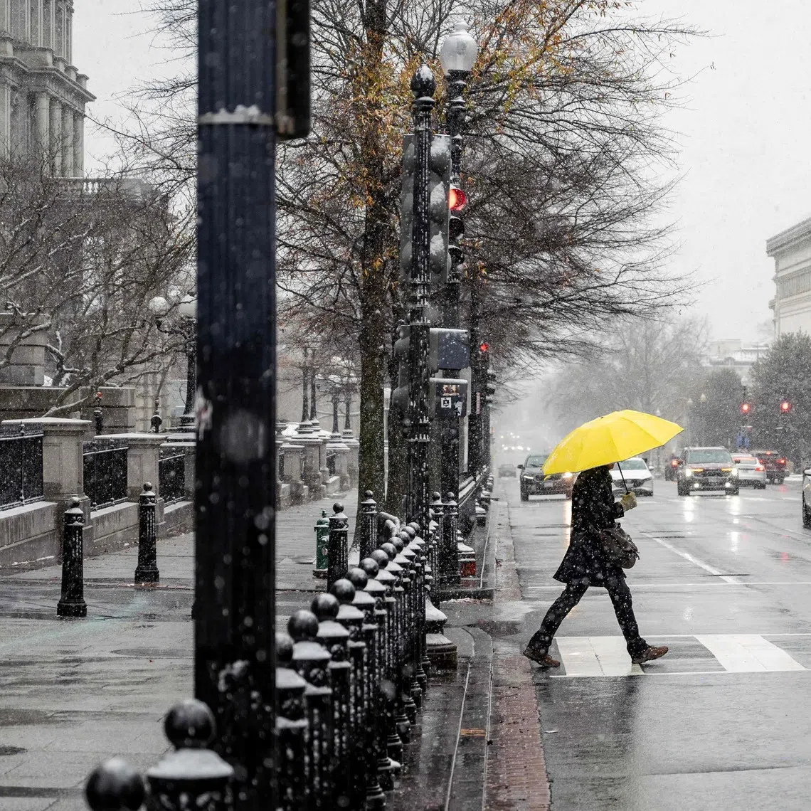 A man crosses an intersection in downtown Washington on Dec 6. The Arctic chill was expected to persist in waves over the next week or two.