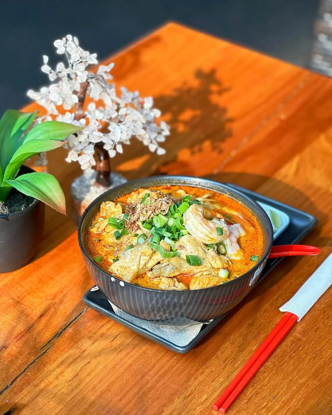 Chow!’s laksa is topped with tofu puffs, bean sprouts and shallots.