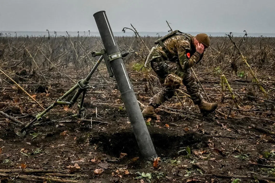 A Ukrainian serviceman fires a mortar on the front line in Ukraine's Zaporizhzhia region.