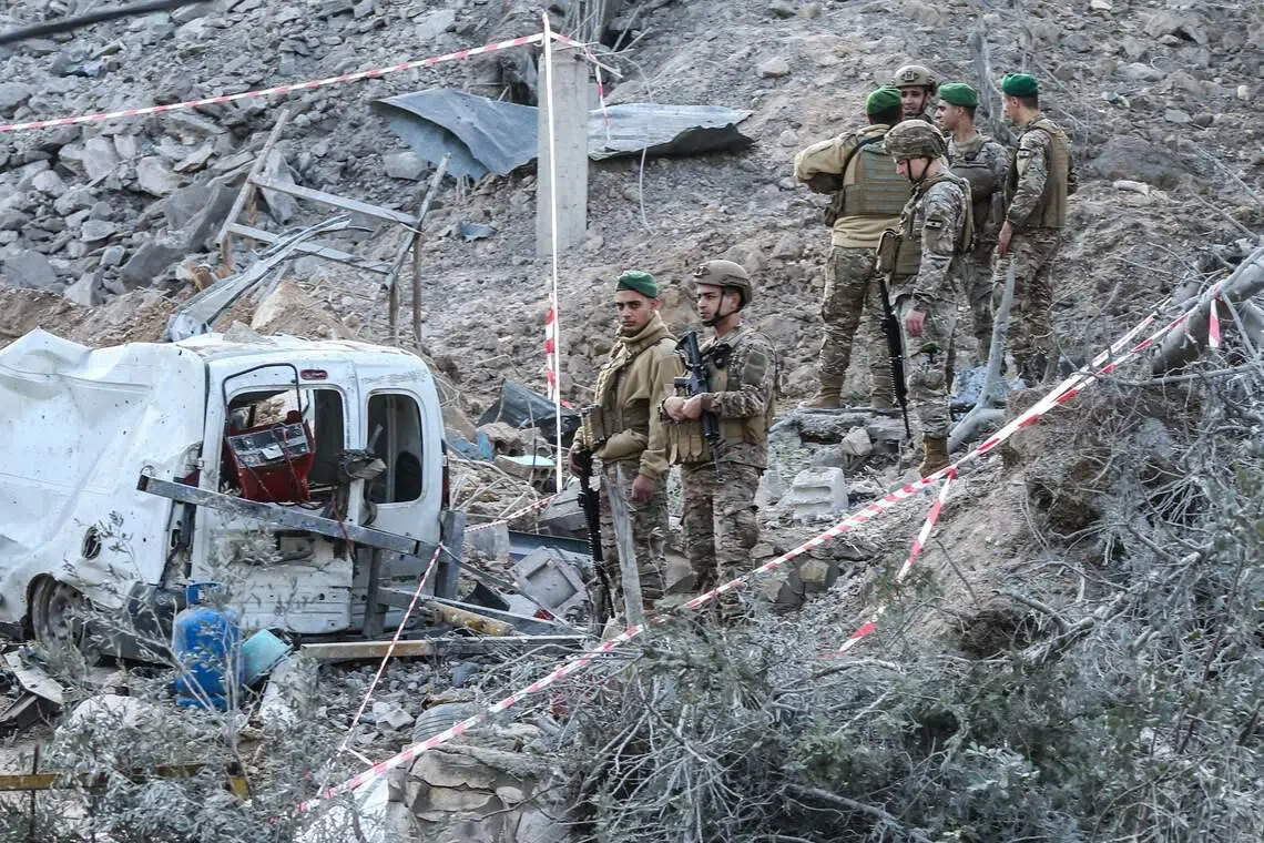 Lebanese soldiers inspecting a site after an Israeli air strike in the southern Lebanese village of Kfar Dounine on Jan 25.