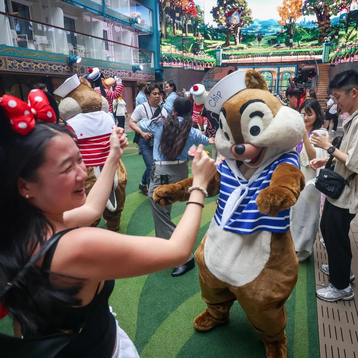 Disney characters dancing with guests onboard Disney Adventure cruise on March 5, 2026. The ship is Asia’s first Disney cruise and can carry up to 6,700 passengers. 