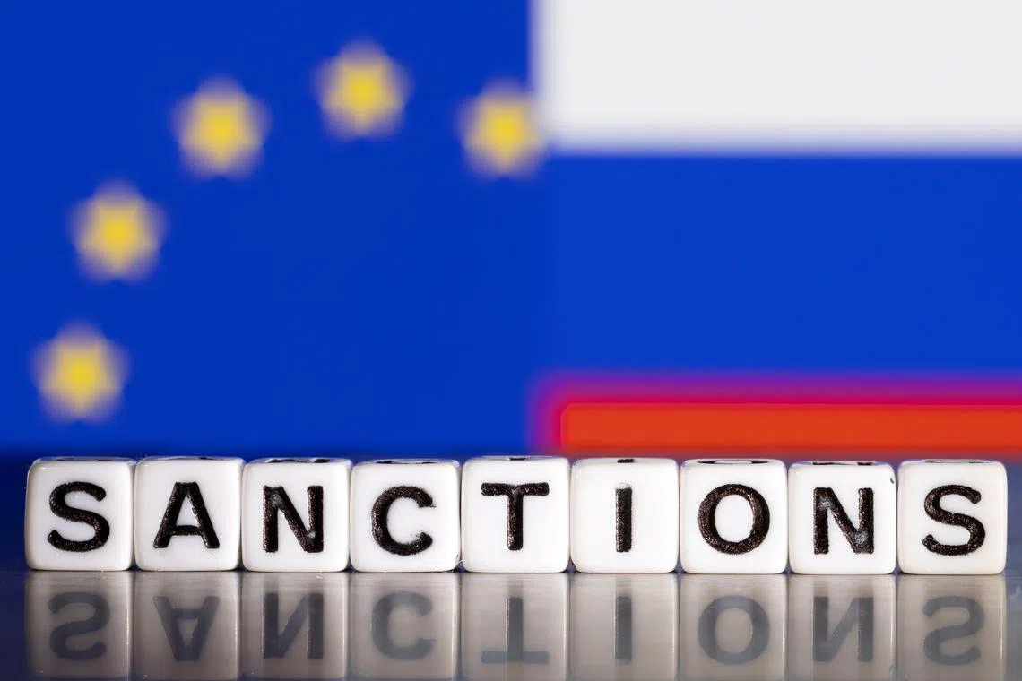 FILE PHOTO: Plastic letters arranged to read \"Sanctions\" are placed in front the flag colors of EU and Russia in this illustration taken February 28, 2022. REUTERS/Dado Ruvic/Illustration/File Photo
