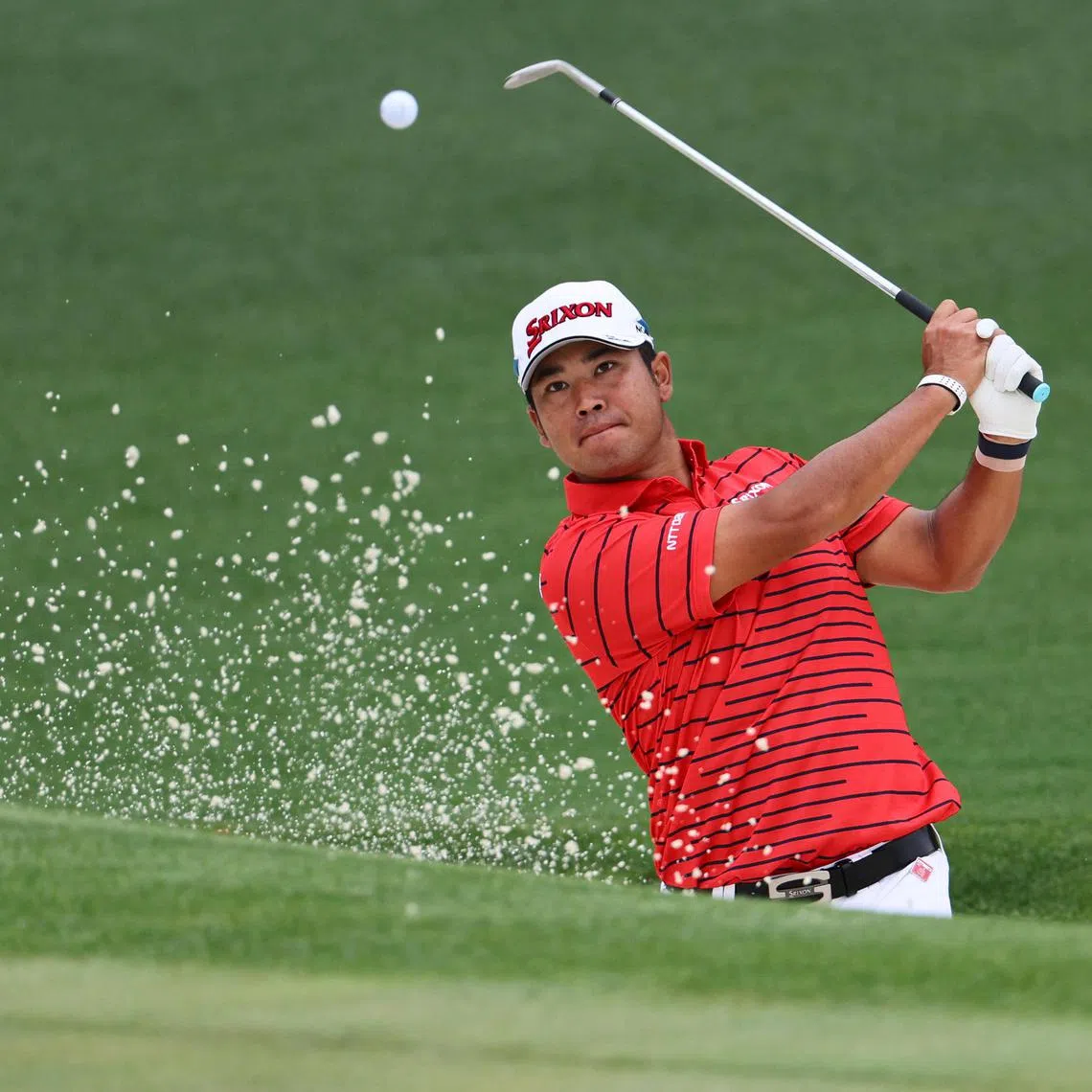Japan's Hideki Matsuyama playing out from the bunker on the 2nd green during a practice round ahead of the Masters at Augusta National.