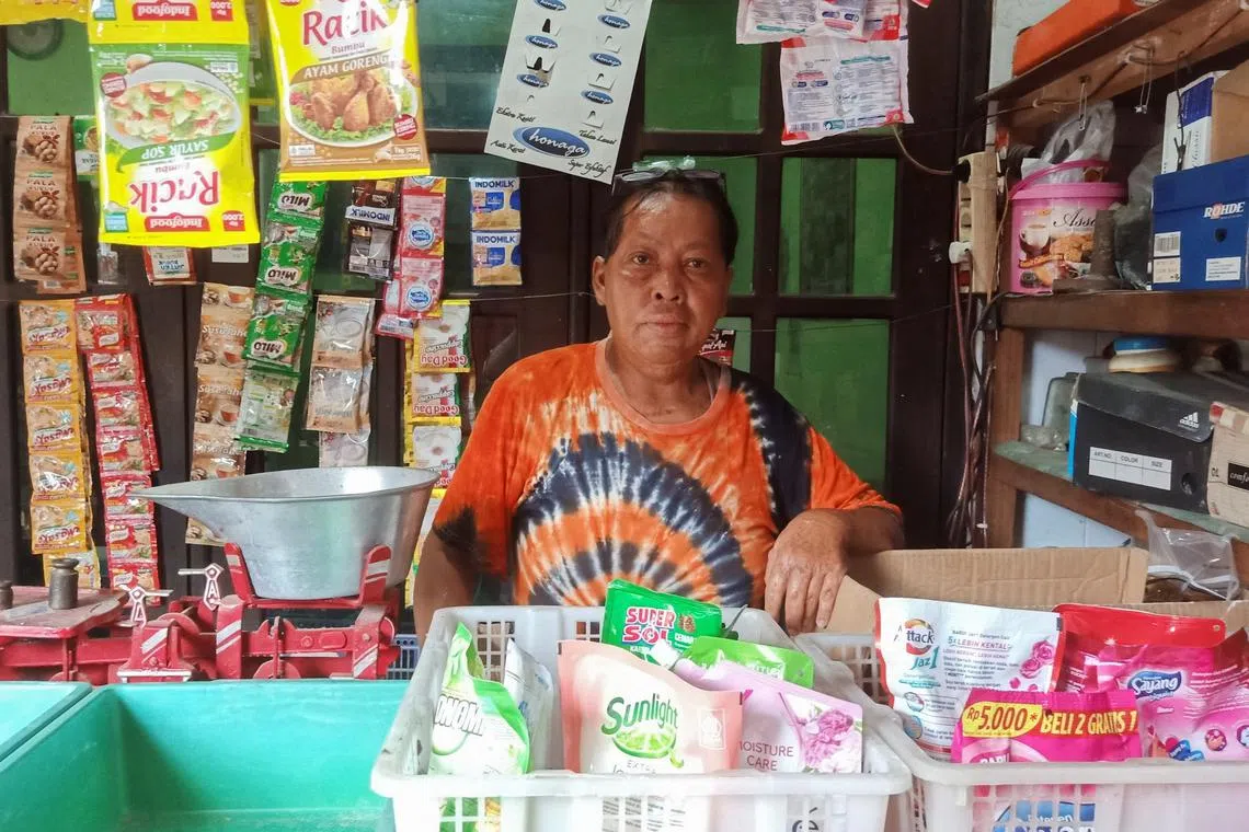 Chusnul Chotimah, 55, a survivor of the bombing in Bali in 2002, who has been relying on funds from Indonesia's victim and witness protection agency (LPSK) for medication and psychiatric assistance, poses for pictures inside his stall in Sidoarjo, East Java province, Indonesia, February 21, 2025. REUTERS/Prasto Wardoyo