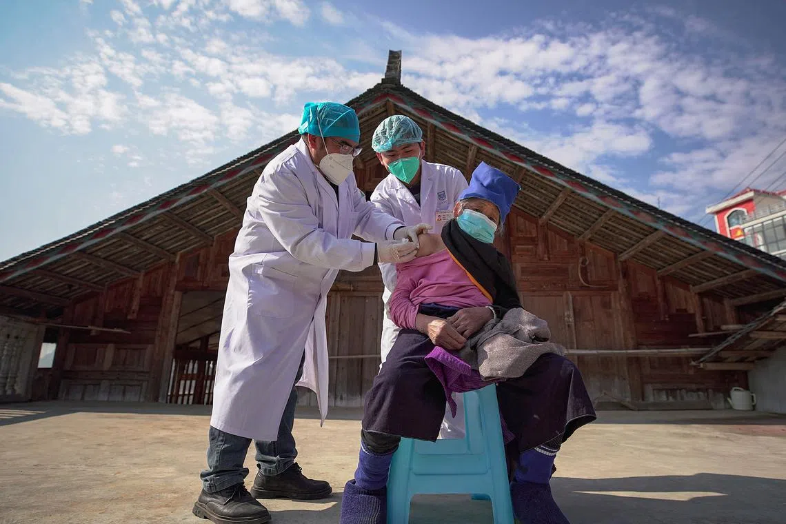 An elderly woman receives a Covid-19 vaccine in Danzhai, in China's southwestern Guizhou province province on December 21, 2022. 