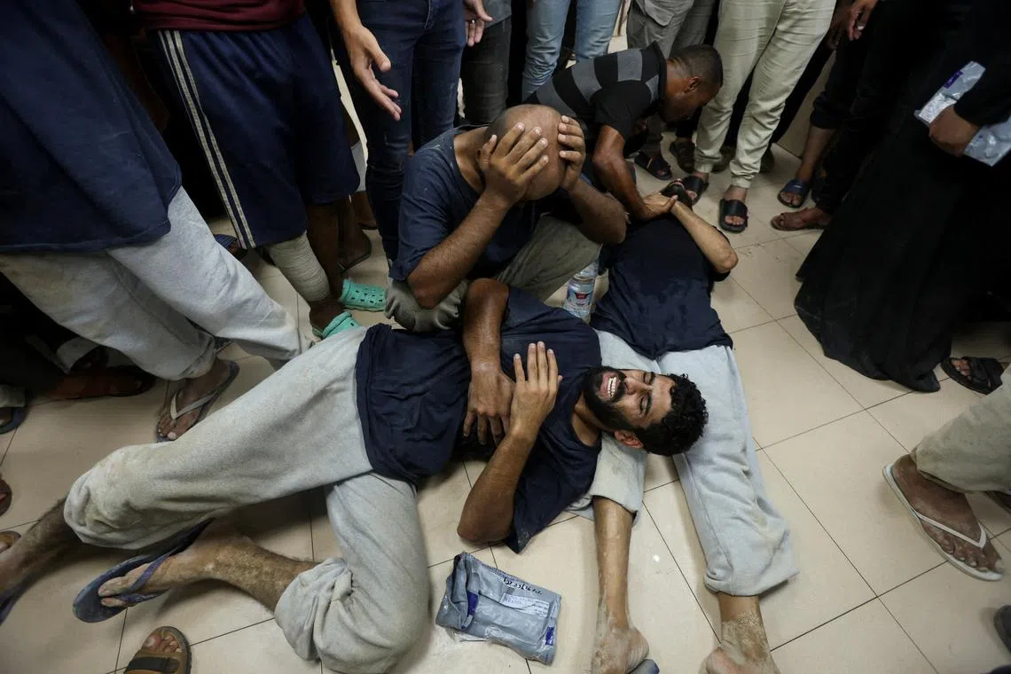 Palestinians who were detained by Israel react after their release, amid the Israel-Hamas conflict, at Al-Aqsa Martyrs Hospital in Deir Al-Balah in the central Gaza Strip, July 25, 2024. REUTERS/Ramadan Abed/File Photo