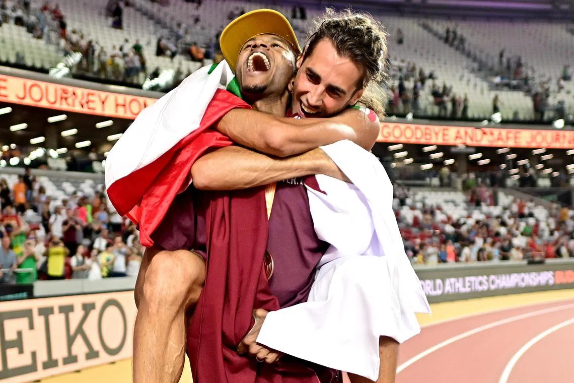 A joyous gold medallist, Gianmarco Tamberi, takes a ride on the back of his friend and rival, Mutaz Essa Barshim, who won the bronze medal, at the world championships. 