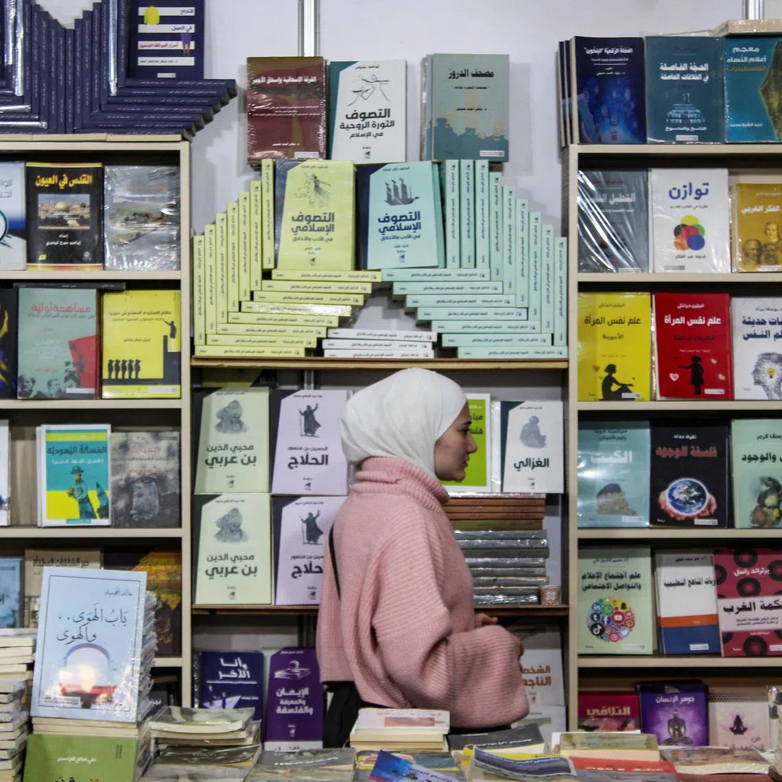 A girl walks through one of the sections at the Damascus International Book Fair, in Damascus, Syria, February 10, 2026. REUTERS/Firas Makdesi