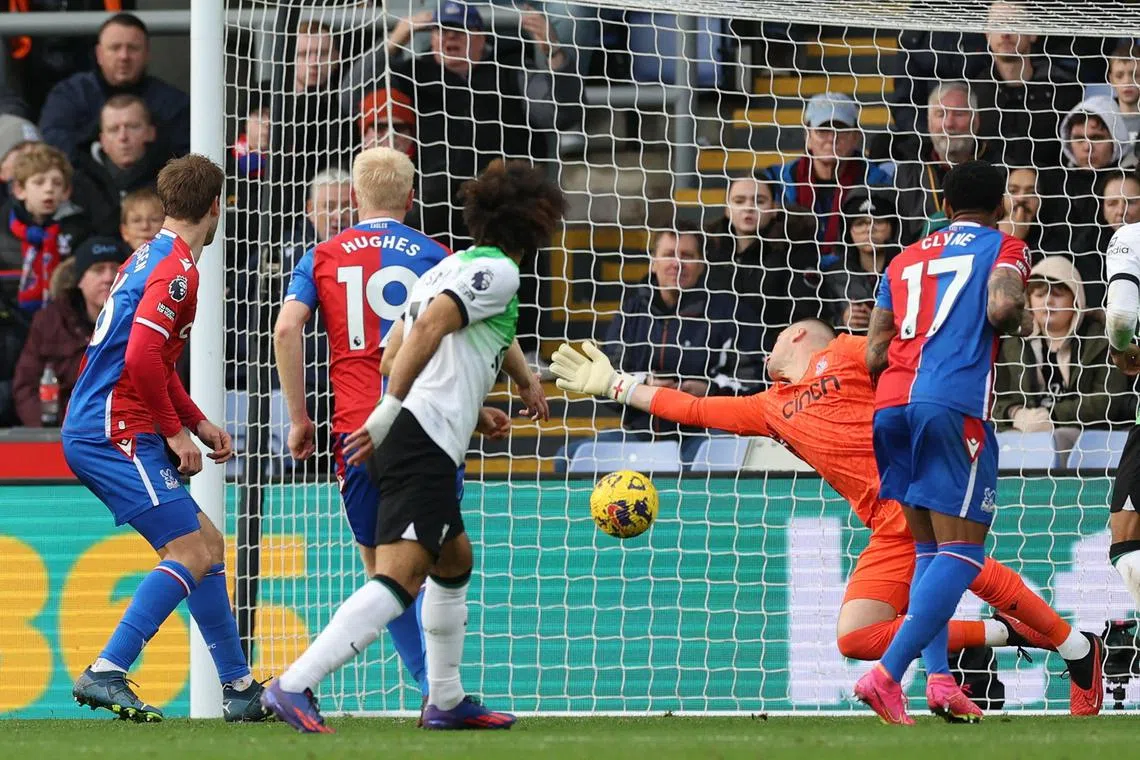 Liverpool's Mohamed Salah (centre) watches as his deflected shot beats Crystal Palace goalkeeper Sam Johnstone for their first goal.