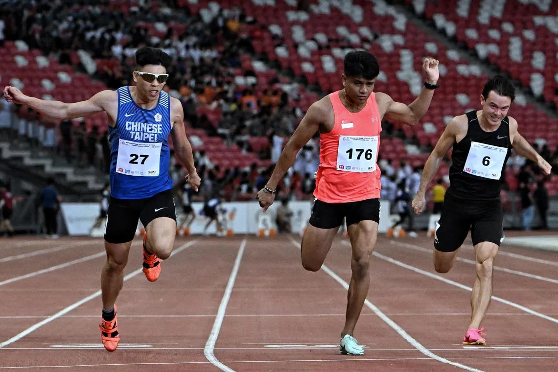 Marc Brian Louis (centre) crosses the 100m finals finish line in second behind Chinese Taipei's gold medalist Lin Yu Sian.