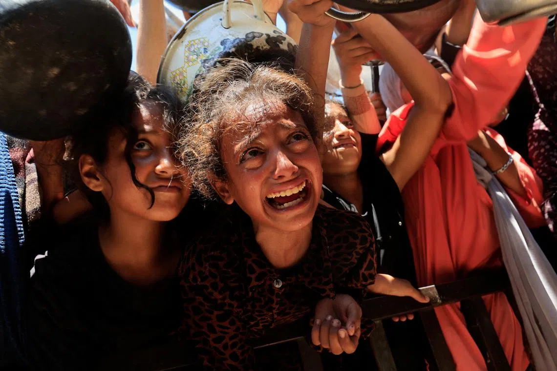Palestinians waiting to receive food from a charity kitchen in Khan Younis, in the southern Gaza Strip, on Aug 4.