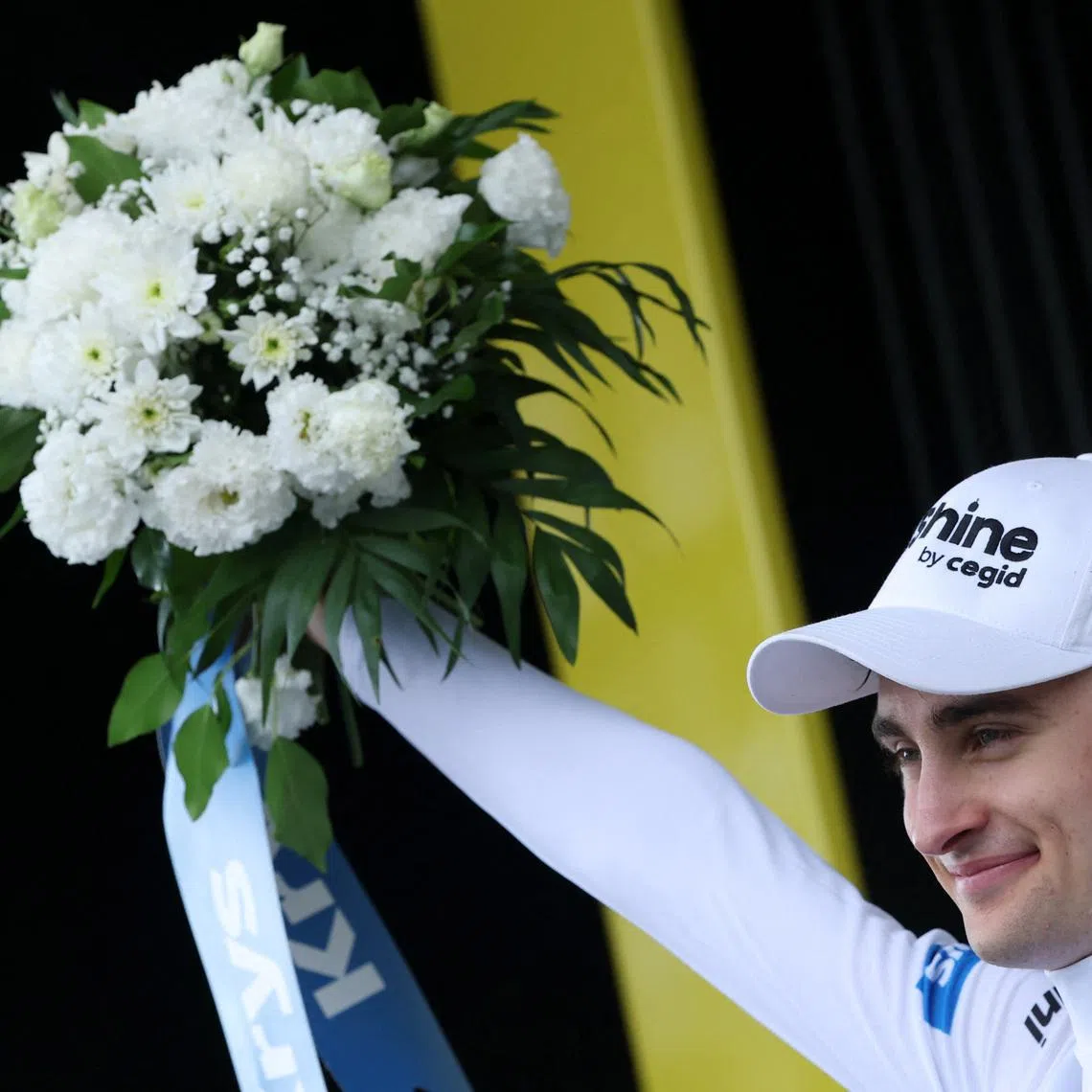 Cycling - Tour de France - Stage 14 - Mulhouse to Le Markstein Fellering - Le Markstein Fellering, France - July 18, 2026 Decathlon CMA CGM Team's Paul Seixas celebrates on the podium wearing the white jersey after stage 14 REUTERS/Gonzalo Fuentes