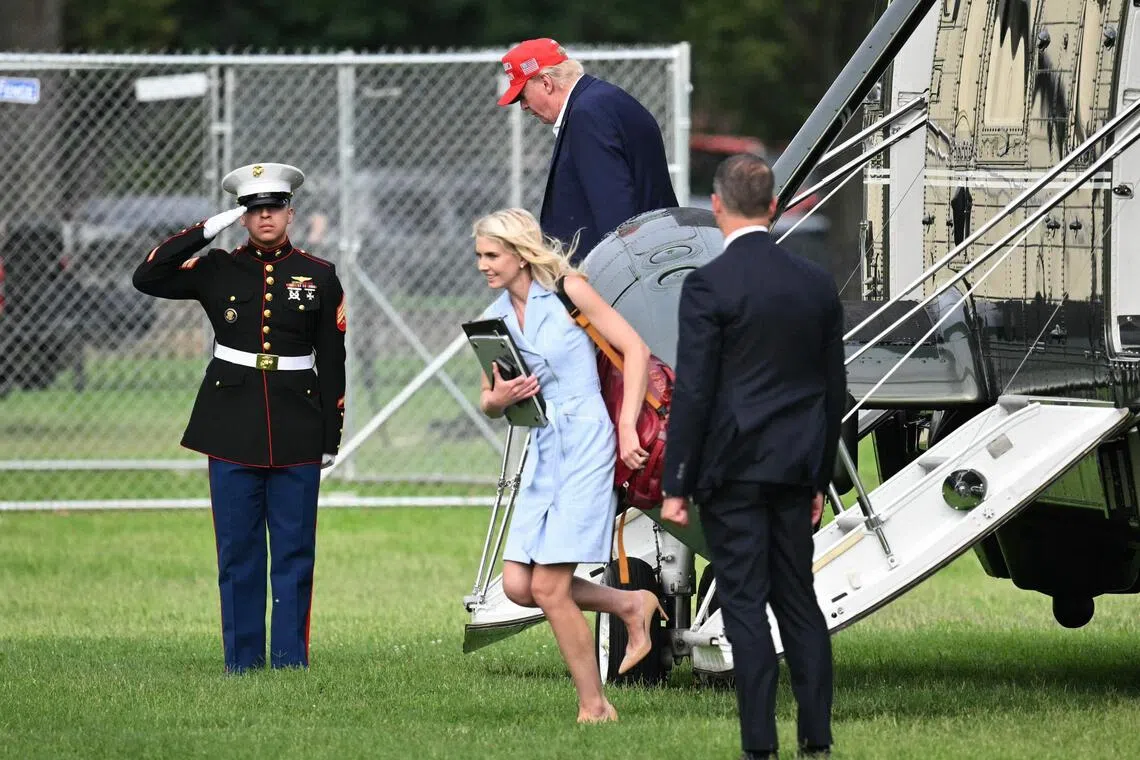 US President Donald Trump and aide Natalie Harp exit Marine One on the Ellipse near the White House on Aug  16.