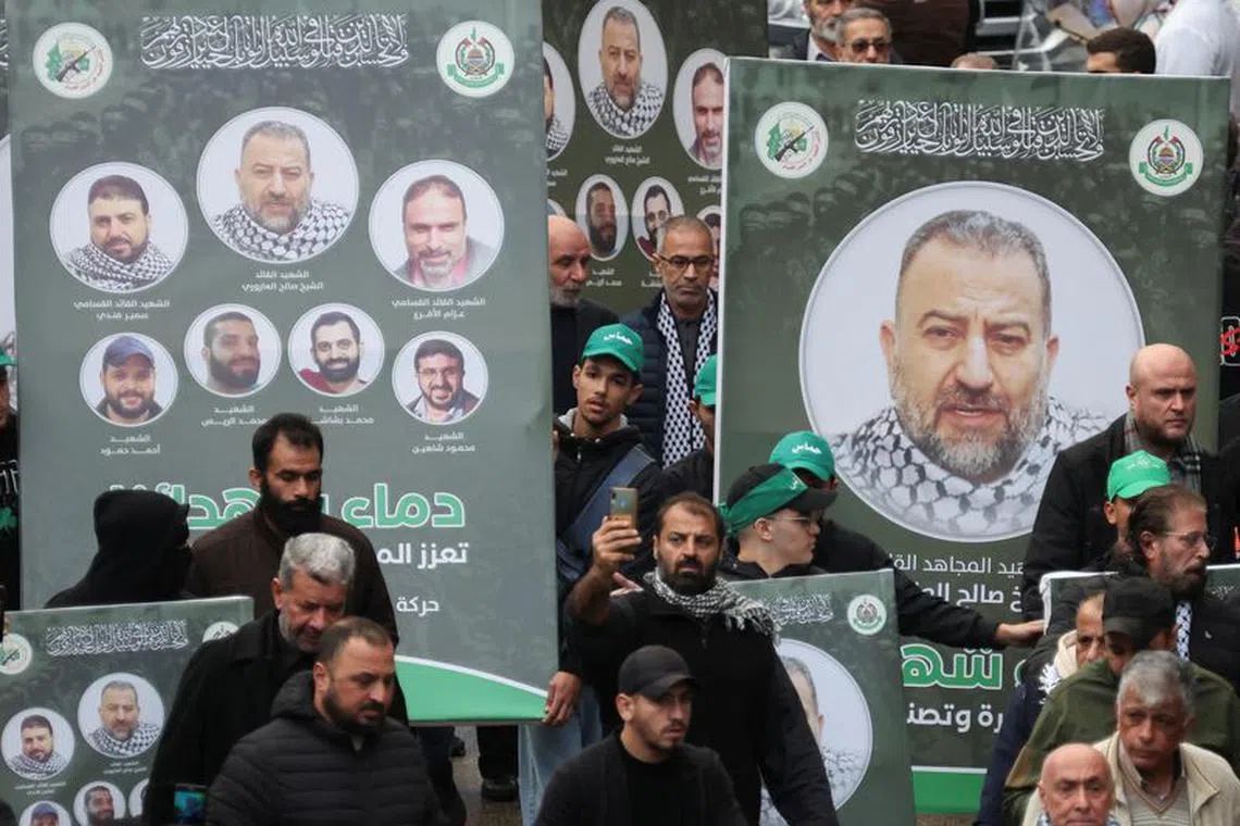 People carry placards with pictures of deputy head of Hamas, Saleh al-Arouri, who was killed by what Lebanese and Palestinian security sources say was a drone strike by Israel, as mourners gather during his funeral in Beirut, Lebanon January 4, 2024. Israel has neither confirmed nor denied that it killed Arouri in the attack. REUTERS/Mohamed Azakir/File Photo