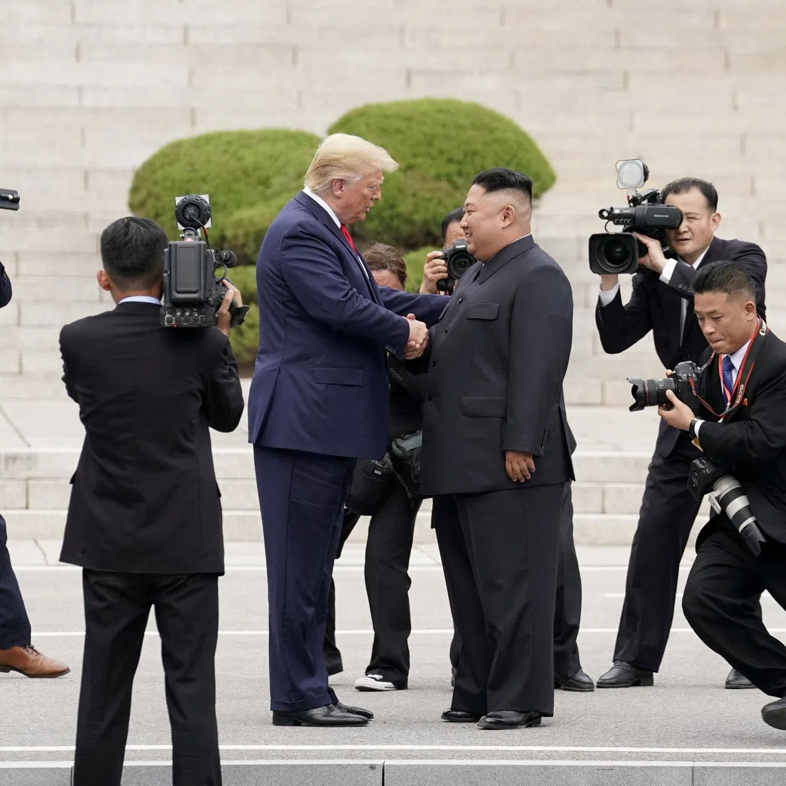 FILE PHOTO: U.S. President Donald Trump meets with North Korean leader Kim Jong Un at the demilitarized zone separating the two Koreas, in Panmunjom, South Korea, June 30, 2019. REUTERS/Kevin Lamarque/File Photo