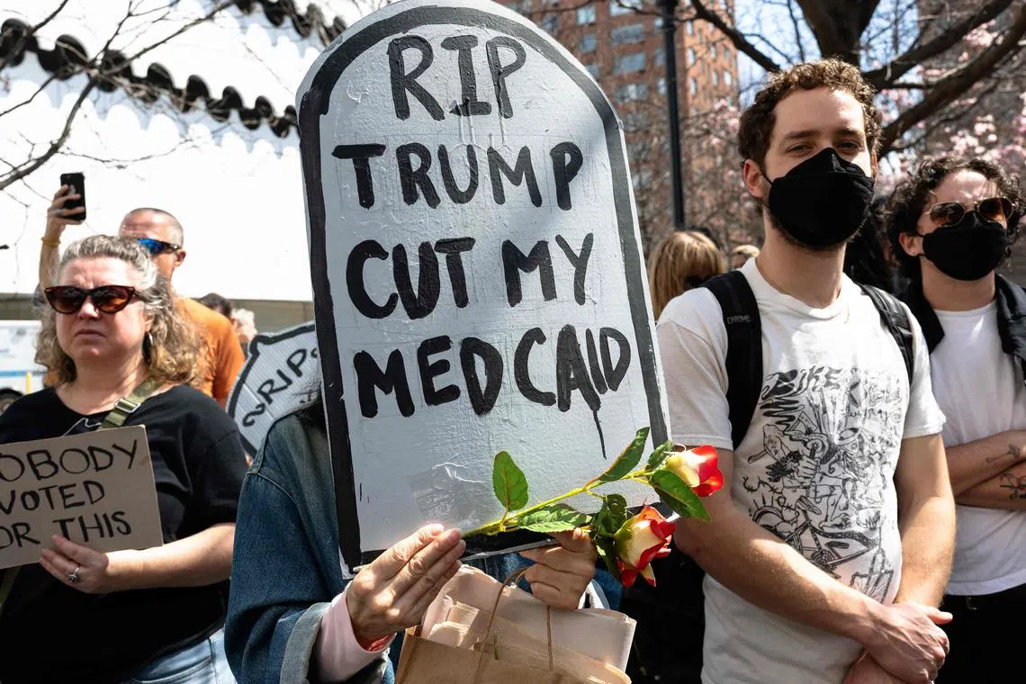 Activists protest efforts by the Trump administration to cut healthcare benefits.