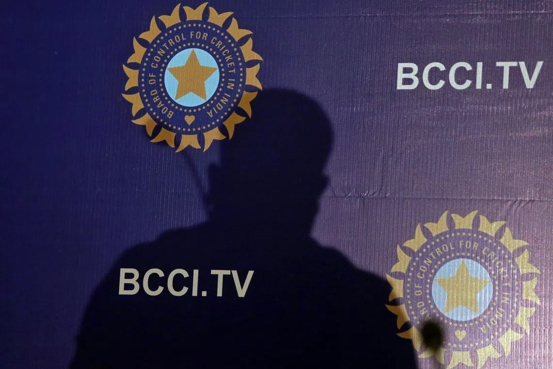 FILE PHOTO: The shadow of a man falls on a backdrop with the logo of the India's cricket board BCCI before the start of a news conference to announce its cricket team's coach, in Mumbai, India, August 16, 2019. REUTERS/Francis Mascarenhas/ File Photo